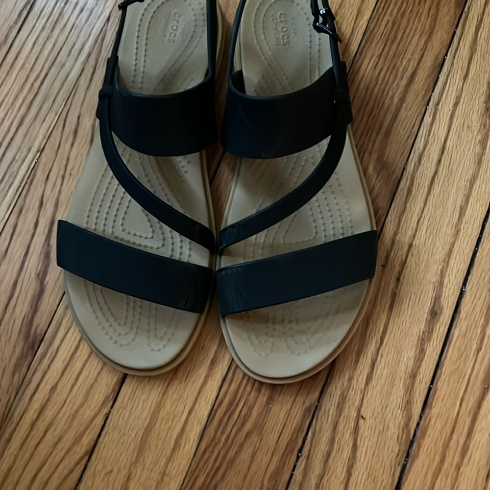Black and tan Crocs sandals